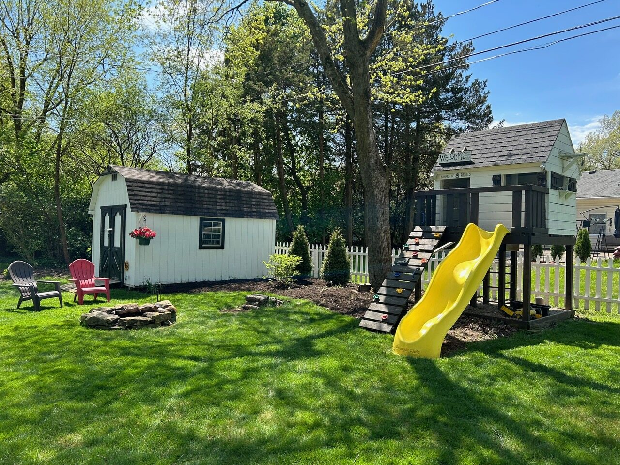 Backyard with the Pirates fort, slide, fire pit and the barn-style shed