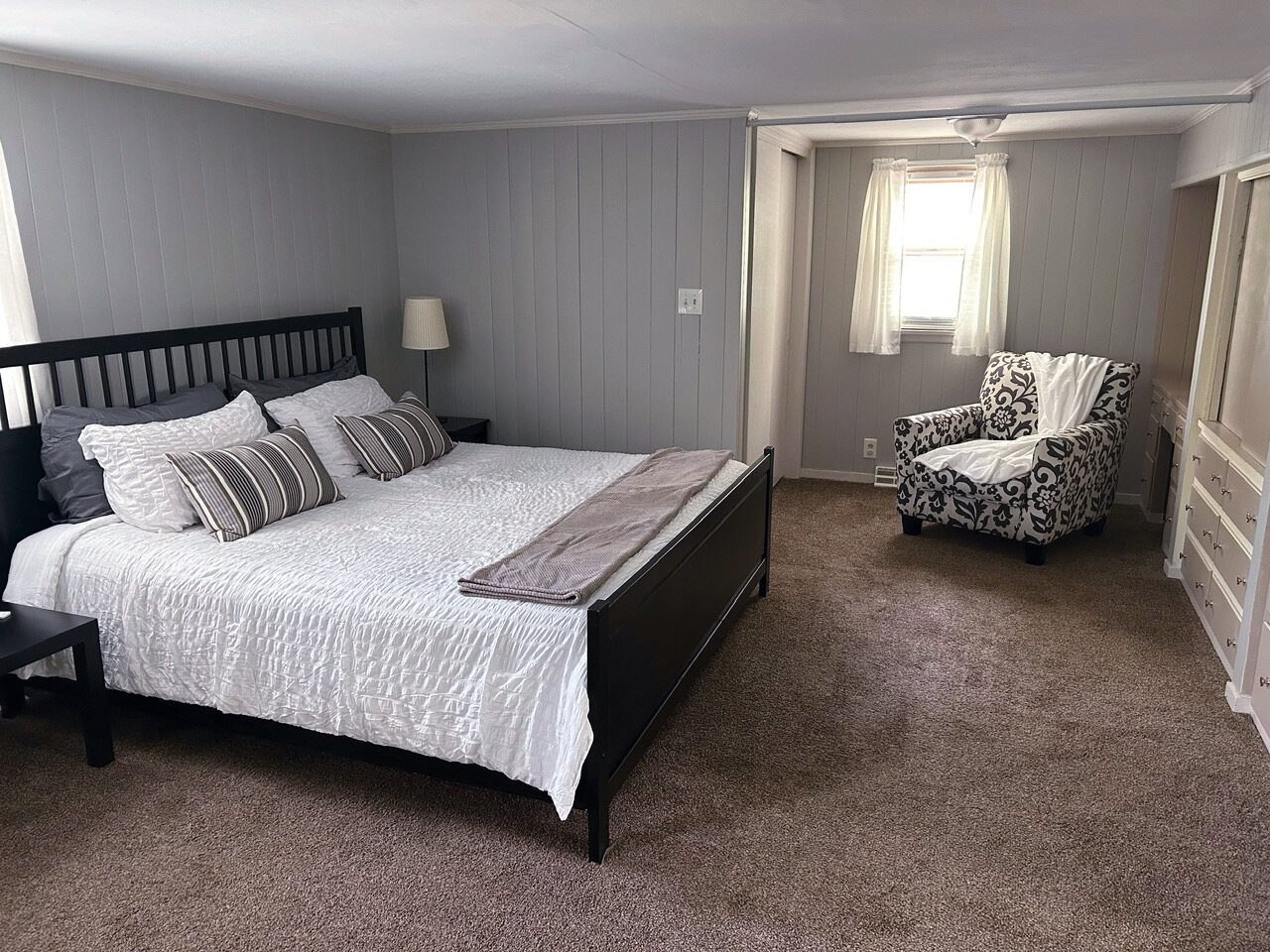 Bedroom with a black bed frame and built-in shelving