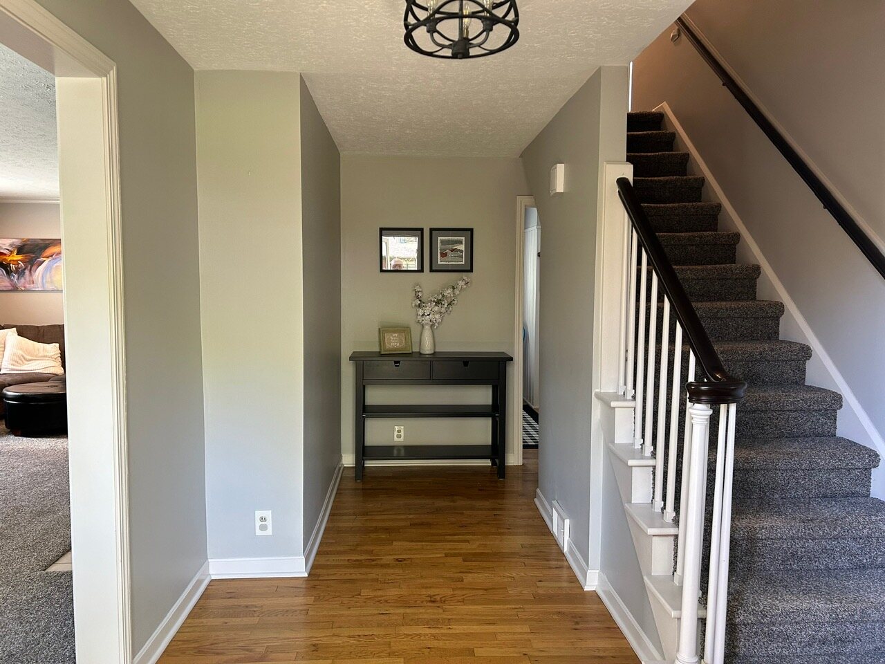 Foyer with hardwood floors and the staircase to the second floor