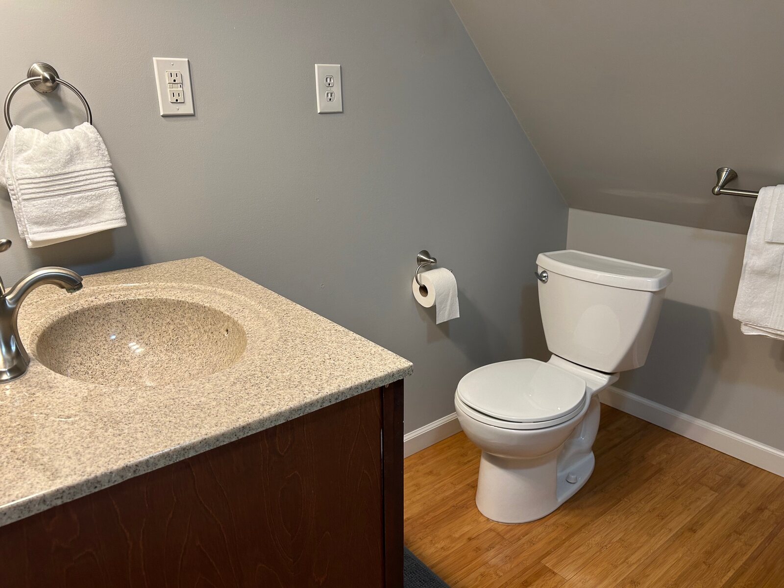 Bath with vanity and toilet under the sloped ceiling