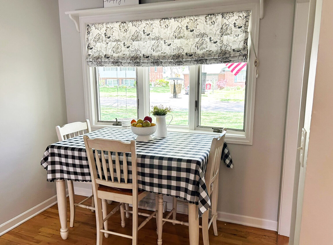 Breakfast nook with a checkered tablecloth by the window