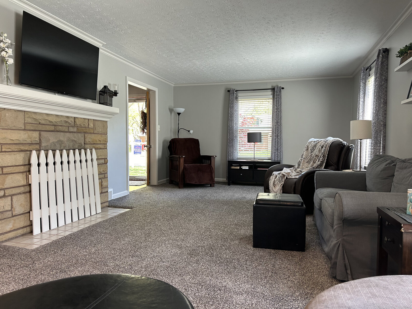 Living room from the fireplace side, television above the mantel