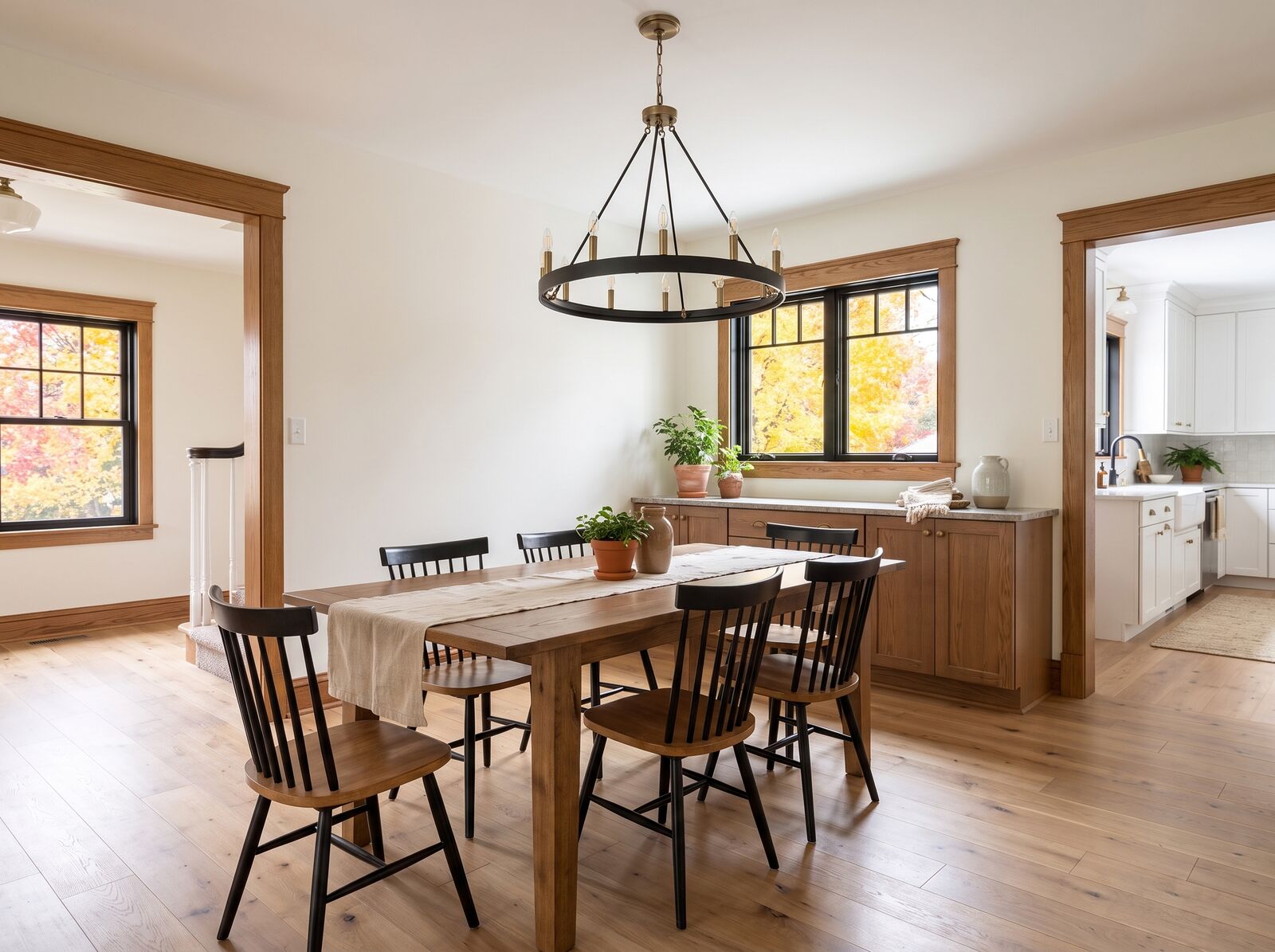 Illustration: Dining room with a long oak table and a black chandelier
