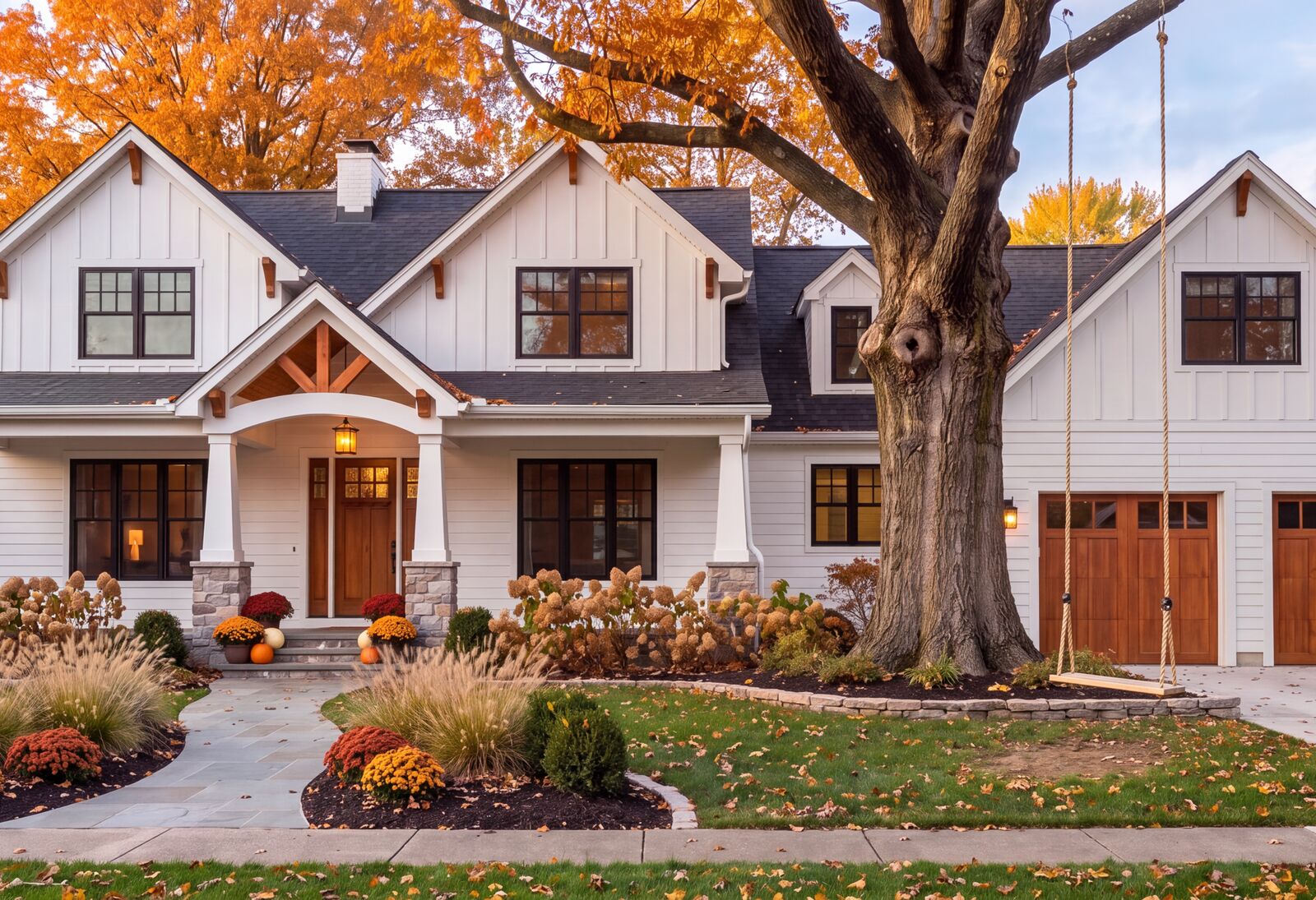Illustration: The front of the house in fall, the rope swing hanging from the big oak